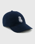 Navy blue cap with a white logo on a light gray background