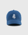 Blue cap with a white logo on a light gray background