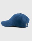 Blue cap with a logo patch on a light gray background