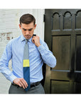 Gray Yellow Blue Tie in Front of Wall and Door