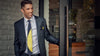 Man with Black Suit and Lesovs Black and Yellow Eclipse tie