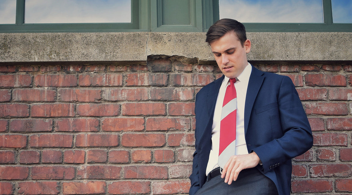 Lesovs Red and Gray Striped Tie on man by bricks