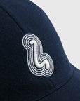 Navy blue cap with a white embroidered logo on a light gray background