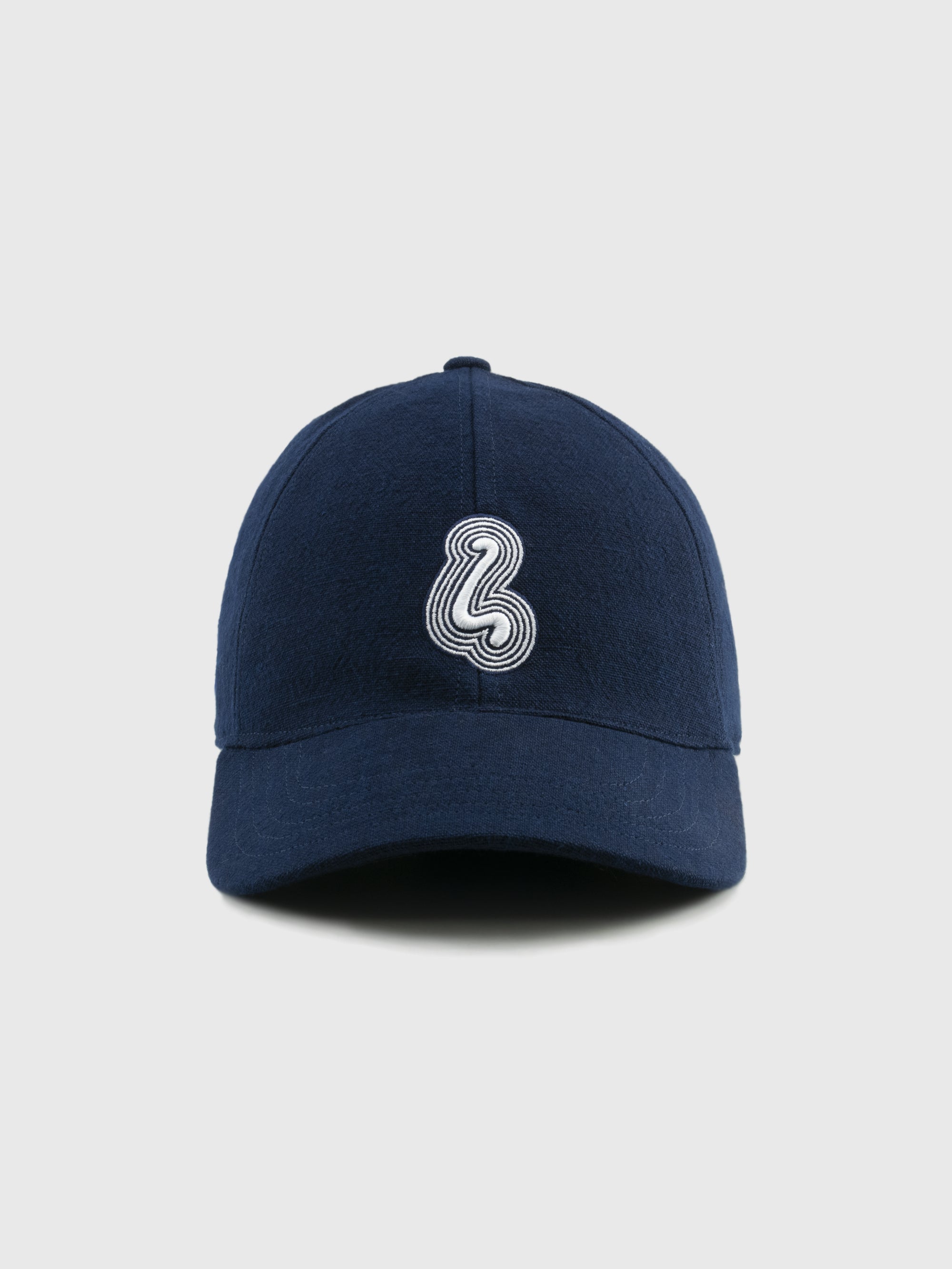 Navy blue cap with a white logo on a light gray background