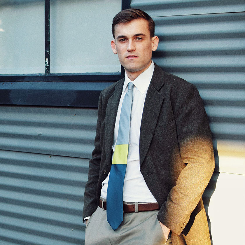 Gray-Blue-Yellow-Block-Lesovs-Tie in front of aluminum building