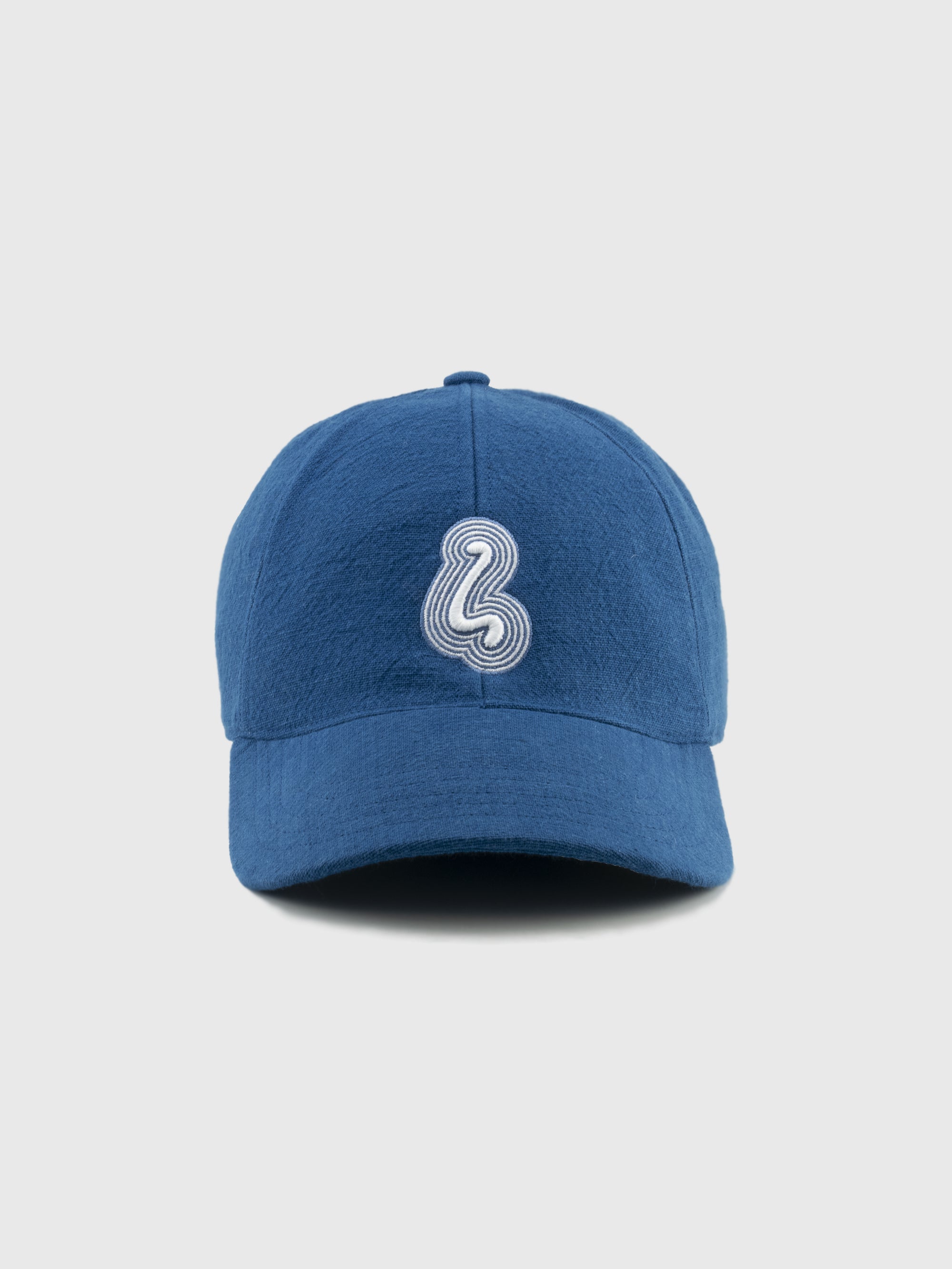 Blue cap with a white logo on a light gray background