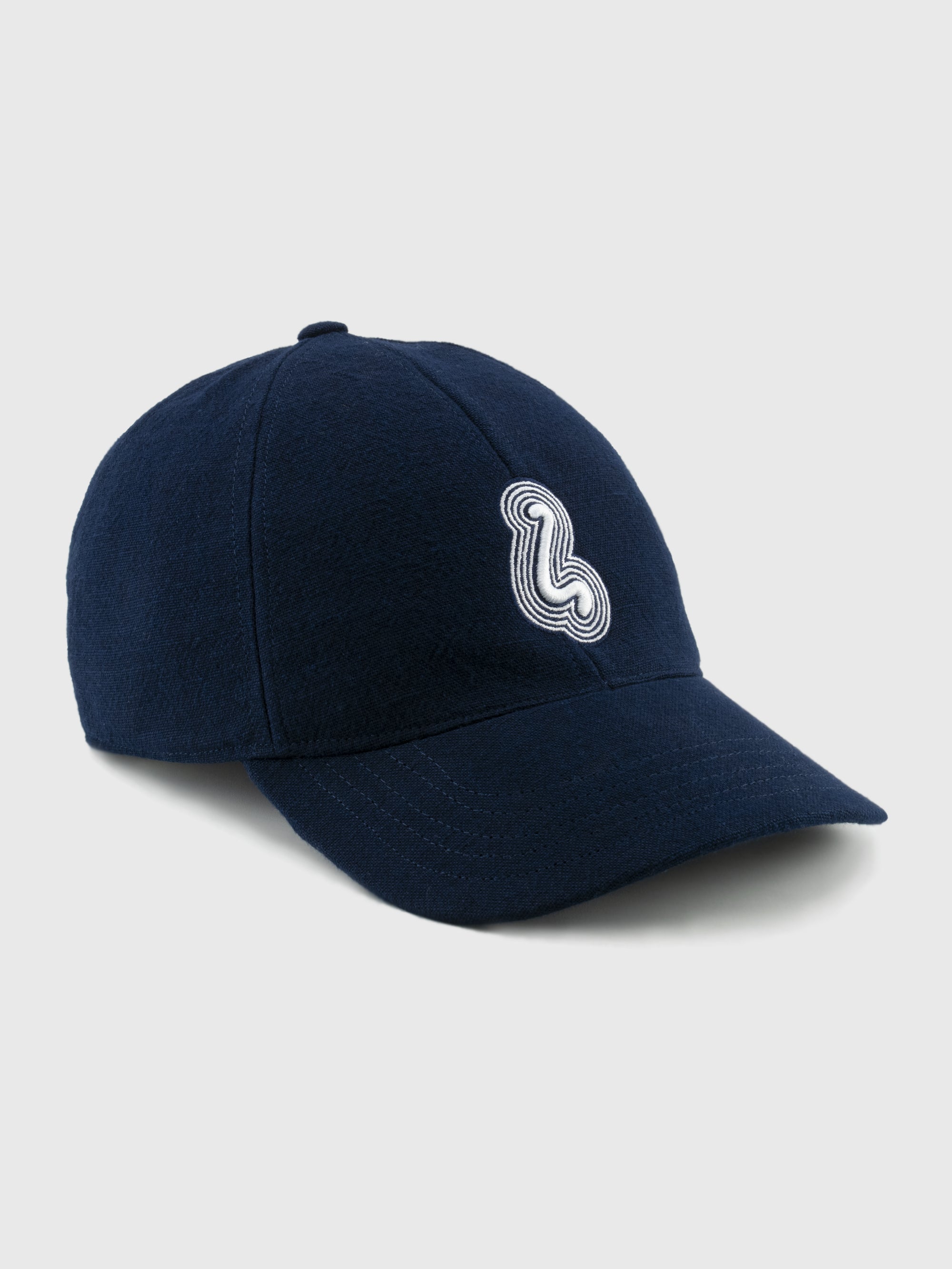 Navy blue cap with a white logo on a light gray background