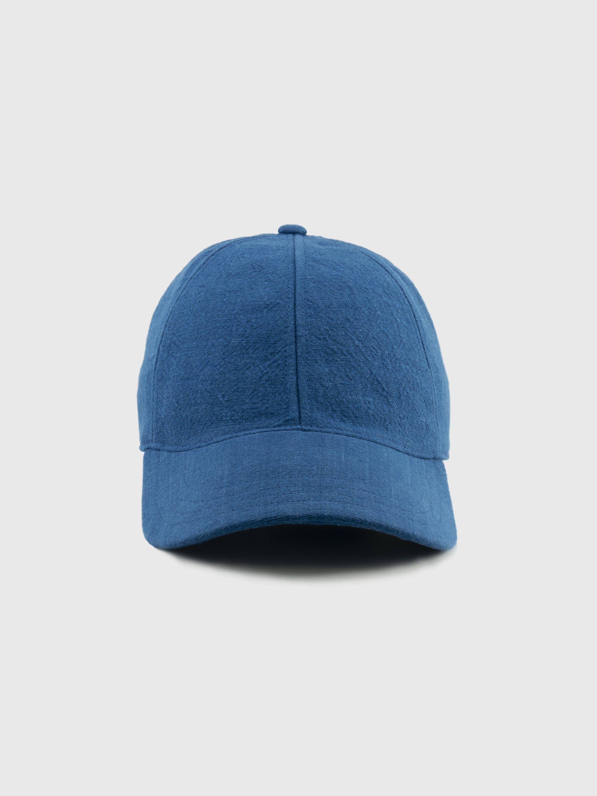 Blue baseball cap on a light gray background