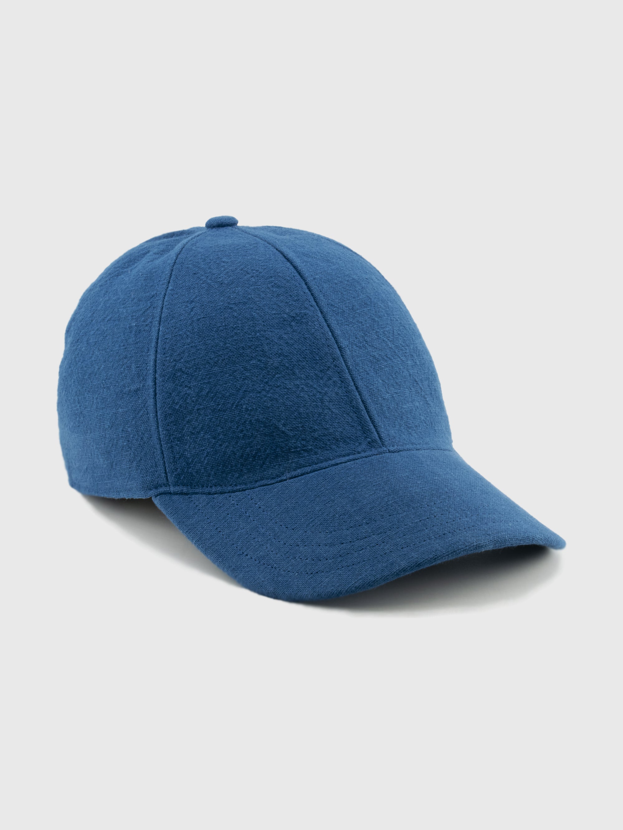 Blue baseball cap on a light gray background