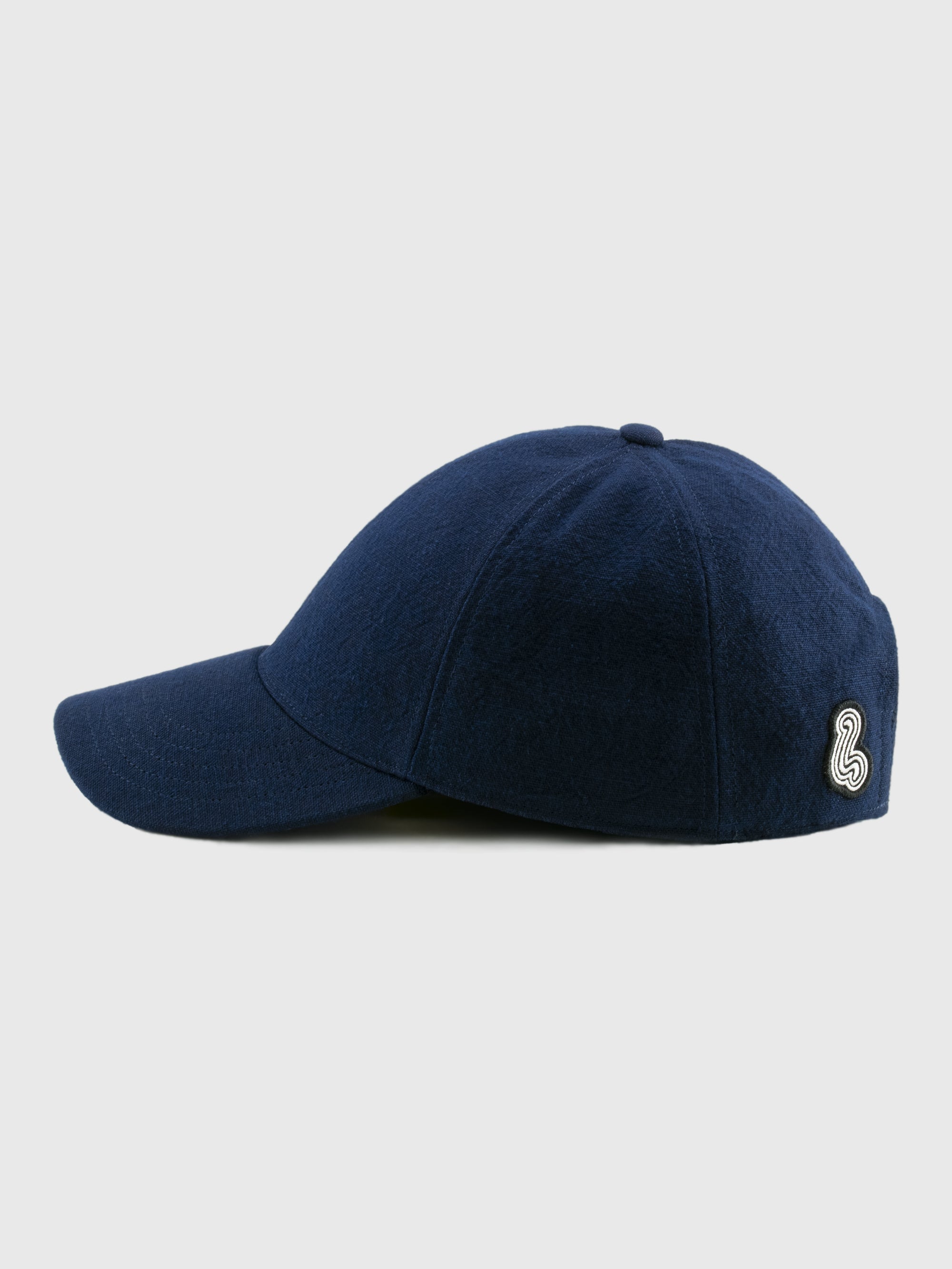 Navy blue cap with a logo on a light gray background