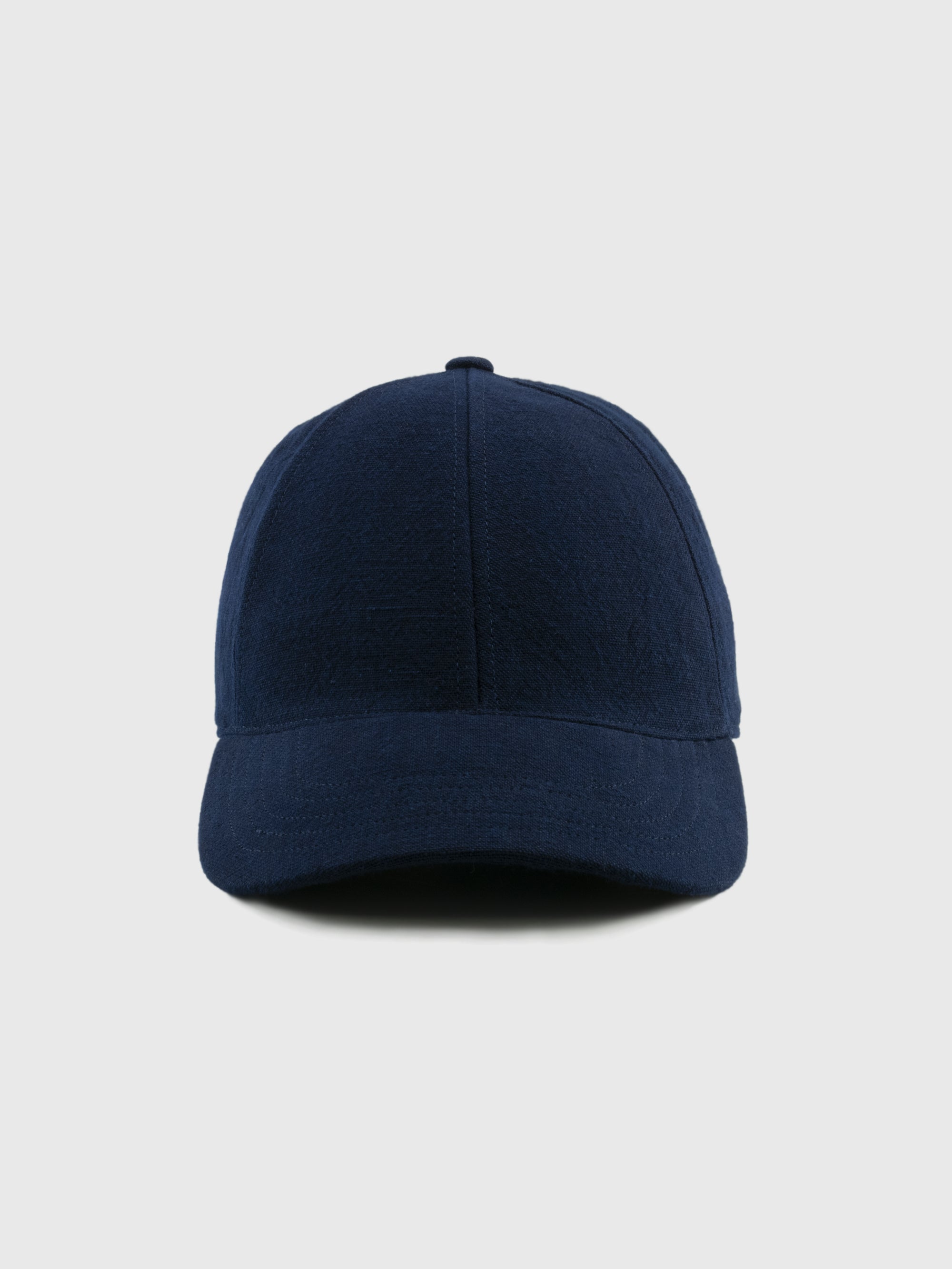Navy blue baseball cap on a light gray background