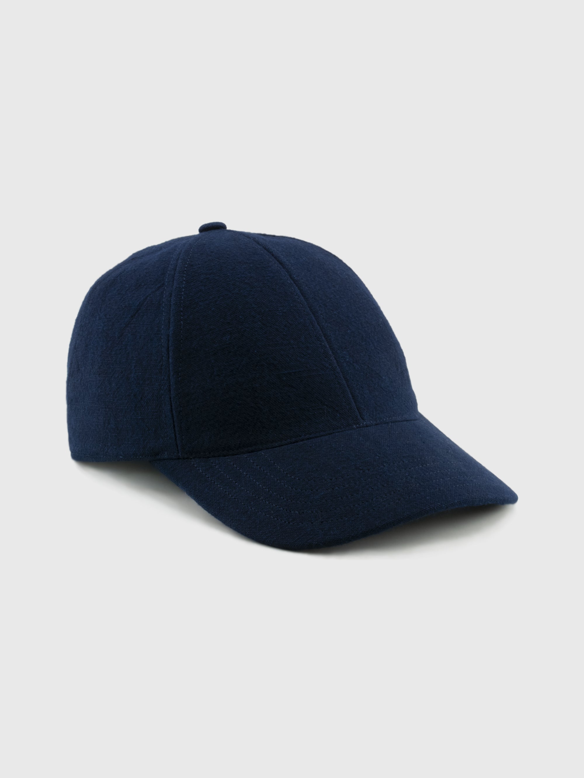 Navy blue baseball cap on a light gray background