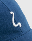 Blue cap with a white logo on a light gray background