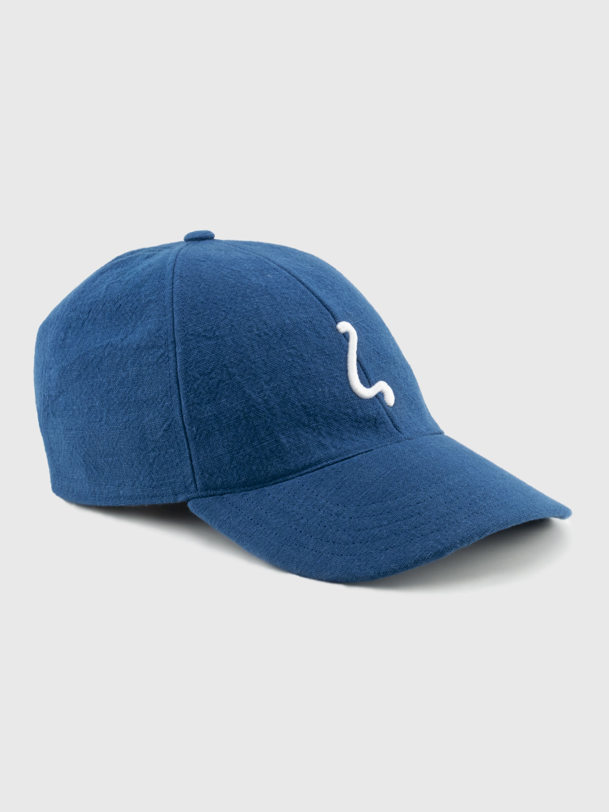 Blue baseball cap with a white logo on a light gray background