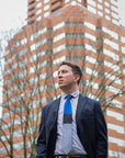 Lesovs Blue Black and Gray Tie in front of building