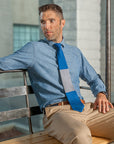 Lesovs Blue and Gray Block Tie Sitting Down