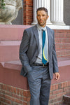 Lesovs Gray Curves Silk Tie on man in front of bricks