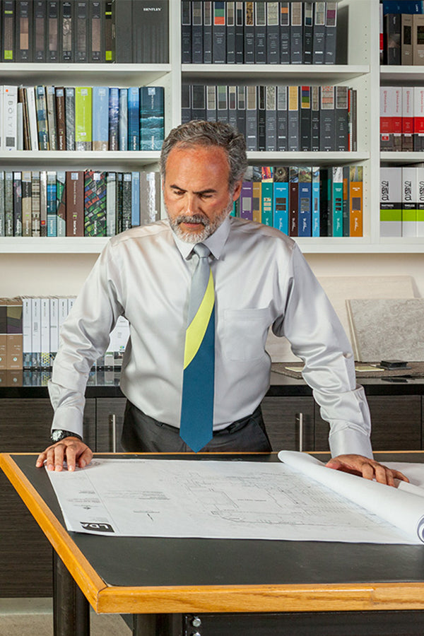 Lesovs Gray Yellow Blue Swoop Silk Tie with designer at table