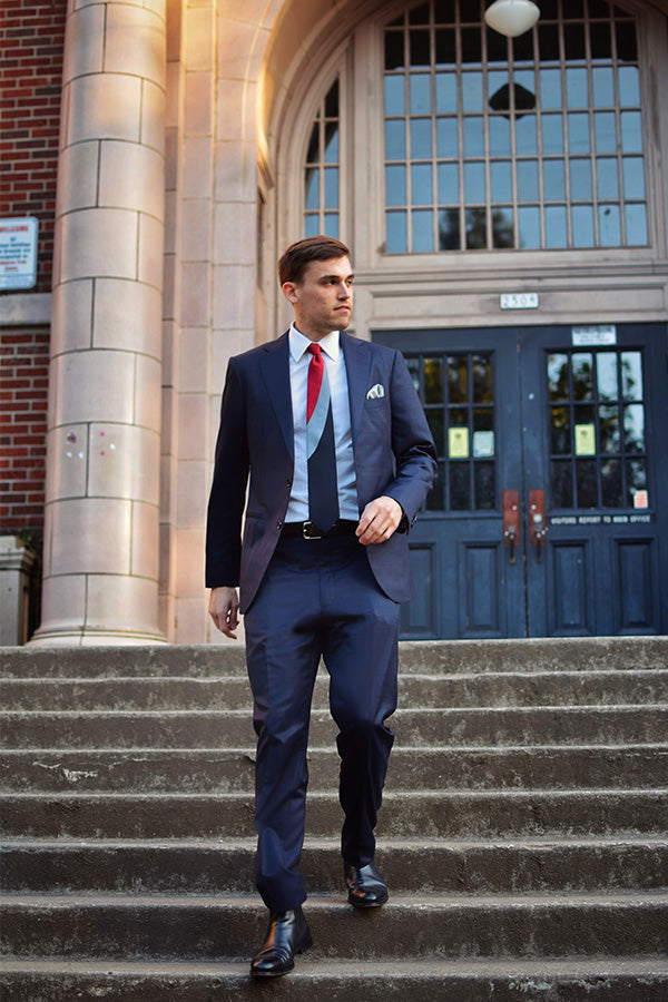 Lesovs Red Swoop Tie with man Walking Down Stairs